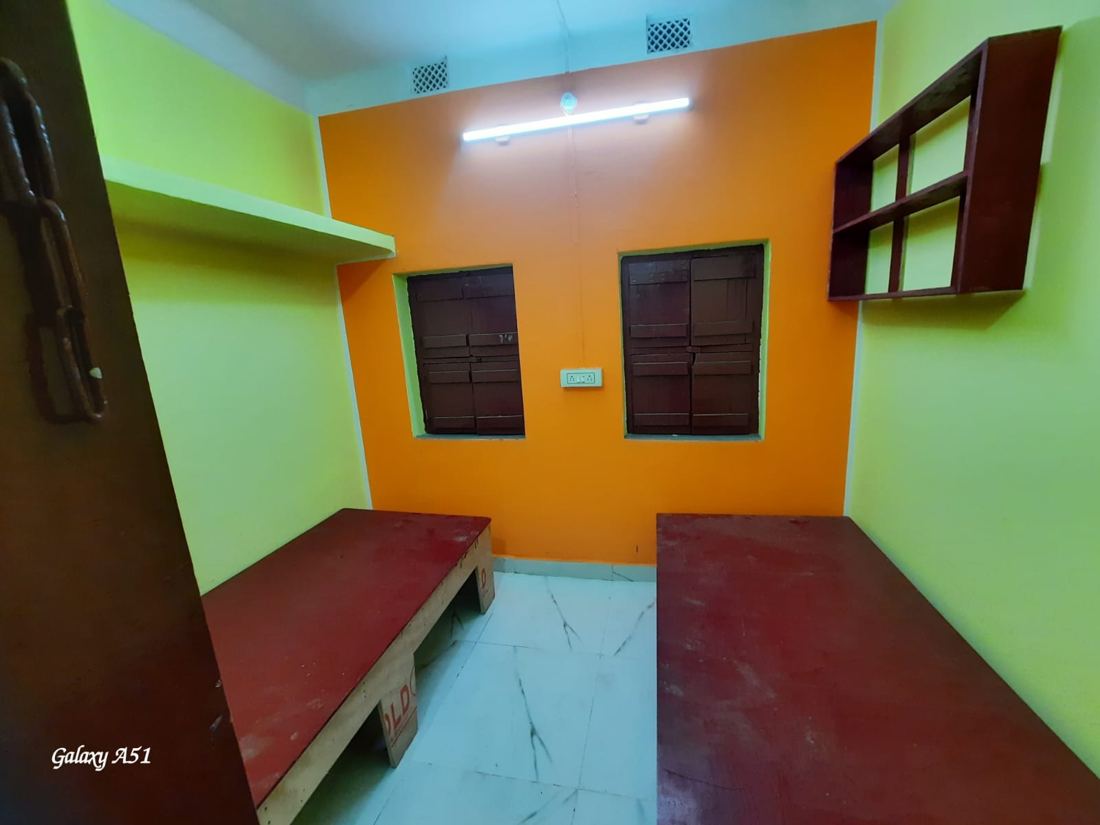 Room with a bed, bookshelf and window